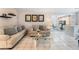 The living room features tiled floors and modern furniture leading to a dining space and kitchen at 2093 Seahurst Dr, Las Vegas, NV 89142