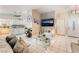 An open concept living room showcasing tile floors, modern decor, and stainless kitchen appliances at 2093 Seahurst Dr, Las Vegas, NV 89142