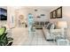 The open floor plan highlights the bright living room with its white tile flooring and modern furniture at 2093 Seahurst Dr, Las Vegas, NV 89142