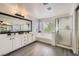 Elegant bathroom with dual vanity sinks, soaking tub, and separate glass-enclosed shower at 2608 Prospector Mine Ave, North Las Vegas, NV 89031