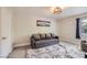 Cozy bedroom with a comfortable sofa and plush rug under a modern light fixture at 2608 Prospector Mine Ave, North Las Vegas, NV 89031
