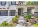 Beautiful home entrance with stone accents, manicured landscaping, and a welcoming front door at 2608 Prospector Mine Ave, North Las Vegas, NV 89031