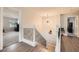 Upstairs hallway featuring a decorative railing, modern lighting, and views into bedrooms at 2608 Prospector Mine Ave, North Las Vegas, NV 89031