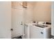 Efficient laundry room featuring a modern washer and dryer set against neutral walls at 2608 Prospector Mine Ave, North Las Vegas, NV 89031