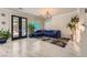Bright living room featuring marble floors, an elegant chandelier, and access to backyard at 2608 Prospector Mine Ave, North Las Vegas, NV 89031
