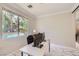 Bright home office with a view of the pool, featuring a modern desk setup and ample natural light at 2608 Prospector Mine Ave, North Las Vegas, NV 89031