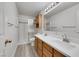 Bathroom features a double sink vanity, shaker cabinets, and a tiled shower with a glass door at 2627 S Durango Dr # 201, Las Vegas, NV 89117