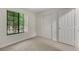 Cozy bedroom featuring carpet, a window with greenery, and closet space at 2627 S Durango Dr # 201, Las Vegas, NV 89117