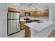 Modern kitchen with stainless steel appliances, white countertops, and wooden cabinets at 2627 S Durango Dr # 201, Las Vegas, NV 89117