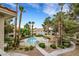 Community pool and lounging area surrounded by tall palm trees and desert landscaping at 2627 S Durango Dr # 201, Las Vegas, NV 89117