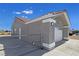 Rear of the home showing a gray exterior, terracotta roof, and gated back yard at 3326 Mount Charleston Dr, Pahrump, NV 89048