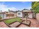 The backyard boasts an artificial turf area, with a patio and additional storage shed, providing a functional outdoor space at 4630 Pratt Way, Las Vegas, NV 89147