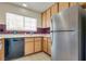 Functional kitchen featuring wood cabinets, stainless steel refrigerator, and a bright window at 4630 Pratt Way, Las Vegas, NV 89147