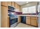 Well-equipped kitchen with stainless steel appliances, wood cabinets, and bright natural light at 4630 Pratt Way, Las Vegas, NV 89147