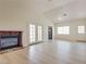 Open-concept living room with fireplace, new floors, vaulted ceilings, and bright lighting fixtures at 4630 Pratt Way, Las Vegas, NV 89147