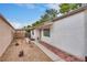 A gravel side yard features a covered walkway leading to the front entrance, offering practical outdoor living space at 4630 Pratt Way, Las Vegas, NV 89147