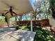 Backyard features a covered patio, landscaped yard, mature trees, and privacy fence at 5517 Overlook Valley St, North Las Vegas, NV 89081