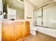 Bright bathroom with tile flooring, framed mirror and a shower with sliding glass doors at 5517 Overlook Valley St, North Las Vegas, NV 89081