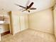 Cozy bedroom with carpet flooring, a ceiling fan and a double door closet at 5517 Overlook Valley St, North Las Vegas, NV 89081