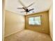 Bright bedroom featuring neutral walls, carpet flooring and a ceiling fan at 5517 Overlook Valley St, North Las Vegas, NV 89081