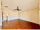 Bright bedroom featuring hardwood floors, a ceiling fan, and neutral-colored walls at 5517 Overlook Valley St, North Las Vegas, NV 89081
