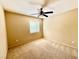 Bedroom features neutral walls, carpet flooring, ceiling fan and window overlooking the backyard at 5517 Overlook Valley St, North Las Vegas, NV 89081