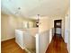 Hallway with hardwood floors, an overhead light fixture, and access to a laundry room at 5517 Overlook Valley St, North Las Vegas, NV 89081