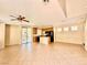 Open-concept living space with tile floors, ceiling fan, and sliding doors to the outdoor patio at 5517 Overlook Valley St, North Las Vegas, NV 89081
