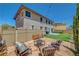Backyard features artificial grass, a patio with a fire pit, and string lights at 5716 Breckenridge St, North Las Vegas, NV 89081