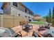 Backyard featuring a fire pit with seating, artificial grass, and string lights at 5716 Breckenridge St, North Las Vegas, NV 89081