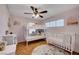 Bedroom features a bunk bed and a crib, with tile floors and natural light at 5716 Breckenridge St, North Las Vegas, NV 89081