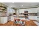 Kitchen with white cabinets, stainless steel appliances, granite countertops, and a center island with bar seating at 5716 Breckenridge St, North Las Vegas, NV 89081