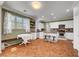 A kitchen with white cabinets, stainless steel appliances, a center island with seating and tile floors at 5716 Breckenridge St, North Las Vegas, NV 89081
