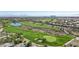 Scenic aerial shot of a golf course and luxury community, highlighting lush greenery, a pond, and beautiful homes at 613 Pinnacle Heights Ln, Las Vegas, NV 89144