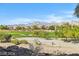 Golf course community home boasts beautiful mountain views, mature trees, and well-maintained landscaping at 613 Pinnacle Heights Ln, Las Vegas, NV 89144