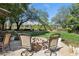 Inviting backyard seating area with fire pit and mature landscaping for outdoor enjoyment at 613 Pinnacle Heights Ln, Las Vegas, NV 89144