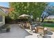 Large backyard patio with outdoor dining area, a firepit and manicured lawn offers a perfect setting at 613 Pinnacle Heights Ln, Las Vegas, NV 89144