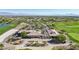 View of clubhouse with well-manicured landscape in a golf community, with parking for many golf carts at 613 Pinnacle Heights Ln, Las Vegas, NV 89144