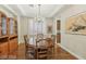 Elegant dining room features hardwood floors, stylish chandelier and cabinet with glass doors at 613 Pinnacle Heights Ln, Las Vegas, NV 89144