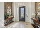 Elegant foyer with tile flooring, console tables, sidelight windows, and a chandelier at 613 Pinnacle Heights Ln, Las Vegas, NV 89144