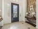 Elegant foyer featuring tiled floors, shuttered sidelights, console table, and a decorative accent wall at 613 Pinnacle Heights Ln, Las Vegas, NV 89144