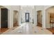 Spacious foyer featuring tile flooring, arched doorways, console tables, and a chandelier at 613 Pinnacle Heights Ln, Las Vegas, NV 89144
