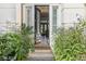 Inviting entryway with an open door, showcasing an elegant interior with tiled floors and chandelier at 613 Pinnacle Heights Ln, Las Vegas, NV 89144