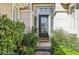 Charming front entrance featuring a decorative glass door and lush landscaping at 613 Pinnacle Heights Ln, Las Vegas, NV 89144