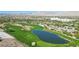 Picturesque aerial shot of the beautiful golf course with a large pond, sand traps, and desert landscaping at 613 Pinnacle Heights Ln, Las Vegas, NV 89144