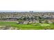 Scenic aerial view of the golf course and adjacent hillside community with lush green fairways at 613 Pinnacle Heights Ln, Las Vegas, NV 89144