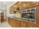 A kitchen with wood cabinets, stainless steel appliances and granite countertops at 613 Pinnacle Heights Ln, Las Vegas, NV 89144