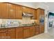 Gourmet kitchen with wooden cabinets, granite counters, and modern stainless steel appliances at 613 Pinnacle Heights Ln, Las Vegas, NV 89144