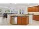 Kitchen island featuring a sink, stainless steel dishwasher, and wood cabinets at 613 Pinnacle Heights Ln, Las Vegas, NV 89144