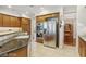 Kitchen with stainless steel appliances, wooden cabinets, and granite countertops at 613 Pinnacle Heights Ln, Las Vegas, NV 89144